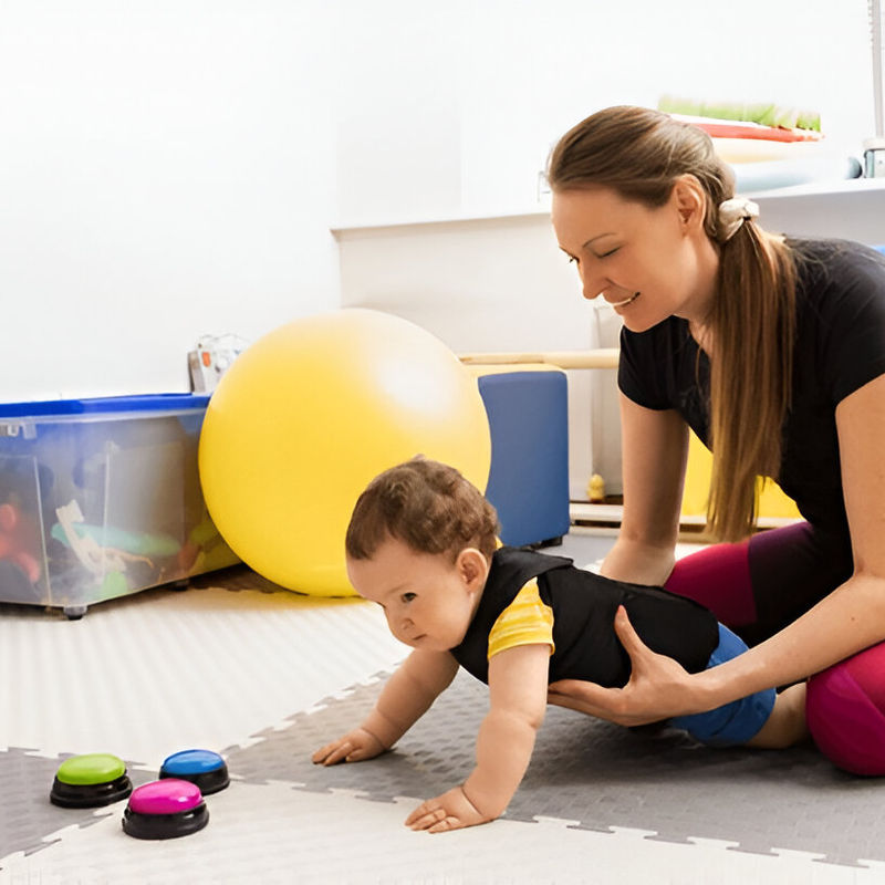 A young child reaching for toys during an early-intervention play session